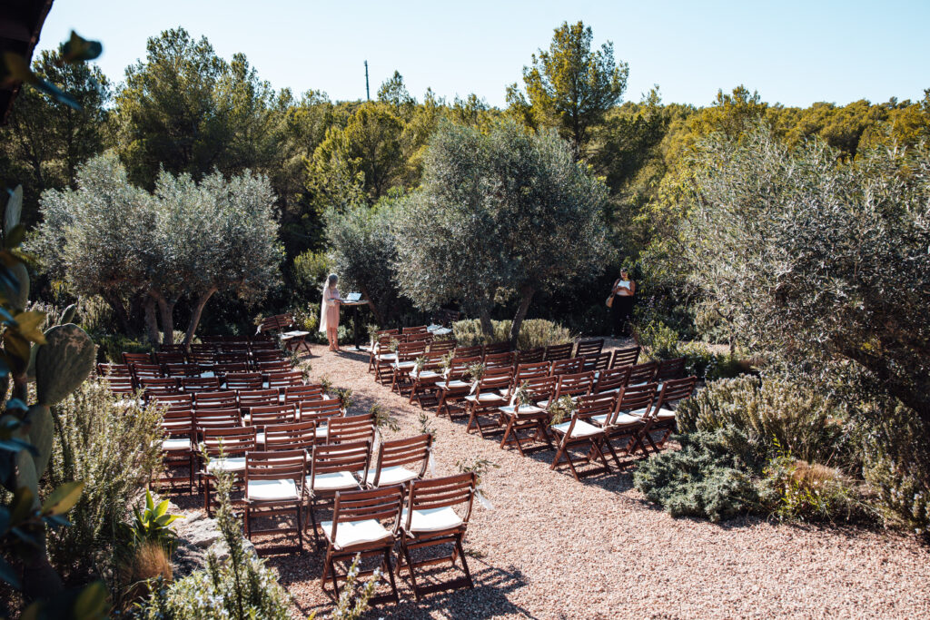 Boho outdoor wedding ceremony in a woodland setting in Ibiza, with greenery and rustic decor